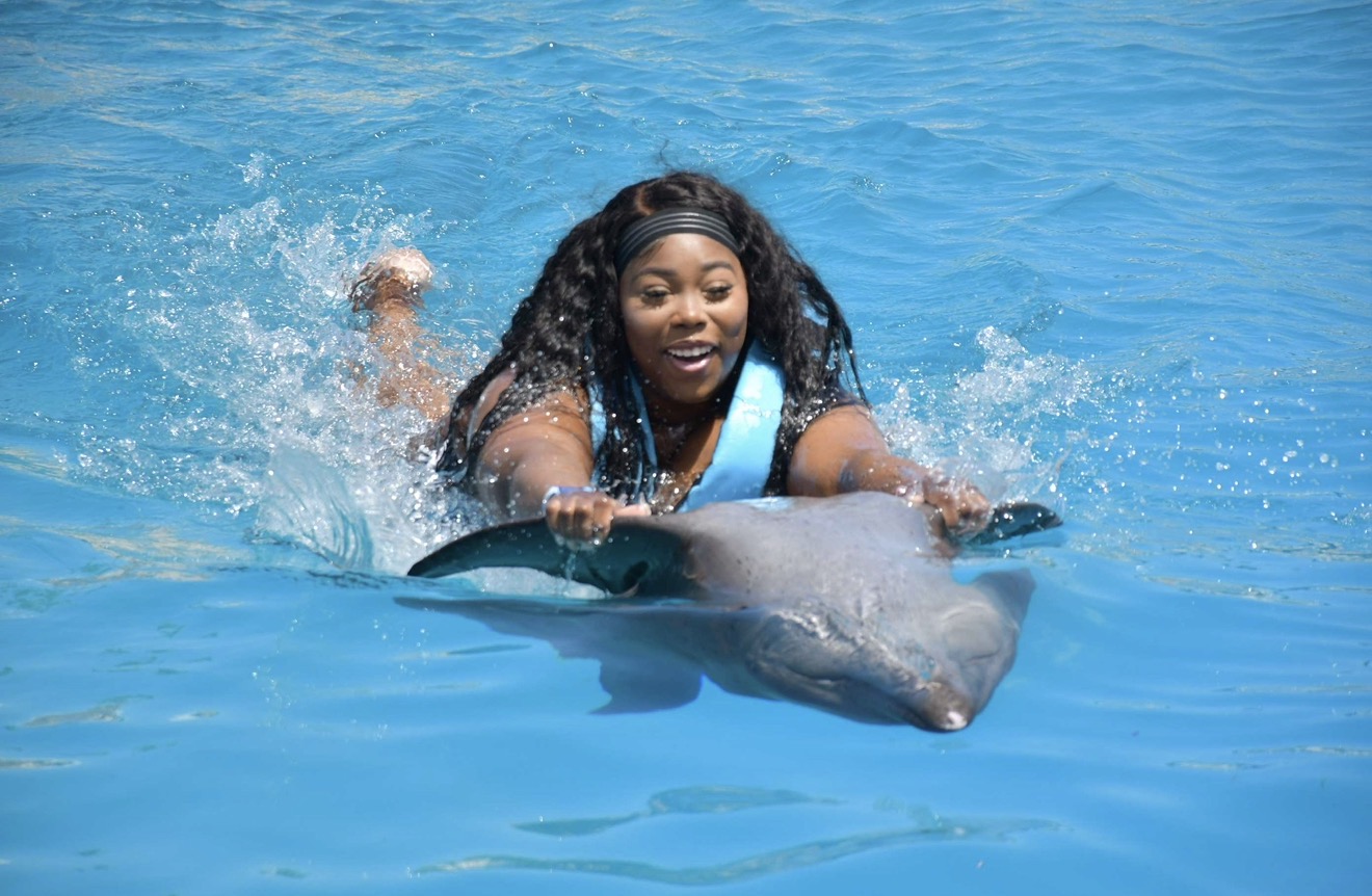 Swimming with a dolphin in Cancún.